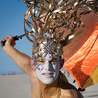 Sometimes accessories are the main focus of a costume, not just an accent. This magnificent headress proves the point with its well-integrated makeup and body paint.